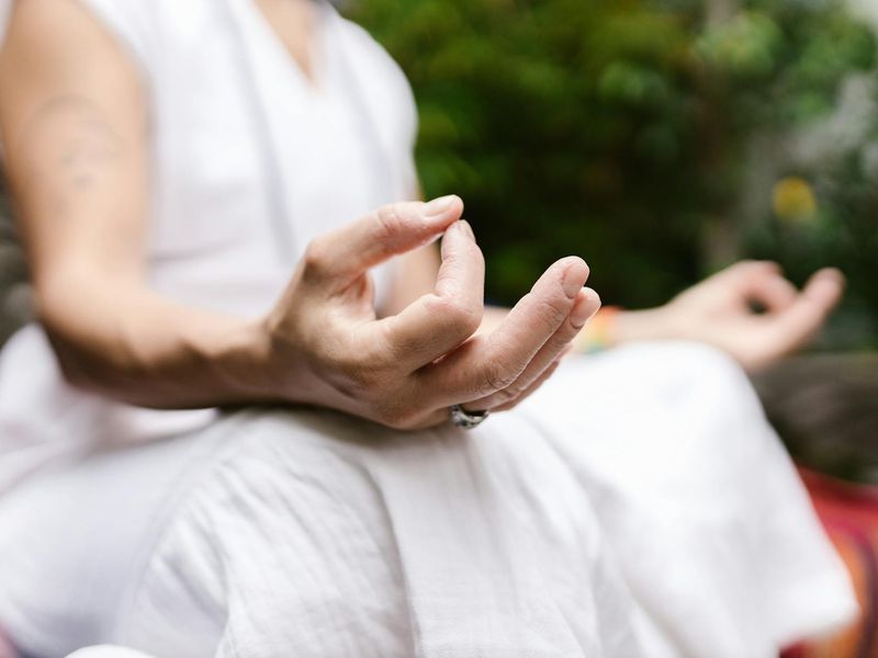 Detailed close-up of hands performing a precise yoga mudra
