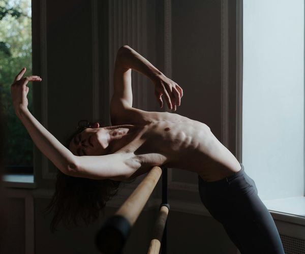 Spacious minimalist room for movement practices with dark floor